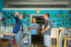 Provost Charles F. Zukoski (left) talks with Darren Cotton (right) and Althea Luehrsen at the University Heights Tool Library. The tool library provided the equipment volunteers needed to work in the community garden. Photo: Douglas Levere