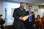 Winner Patrick McDevitt receives the paddle from Andrew Stott, event emcee, dean for undergraduate education and director of the Honors College. Photo: Nancy J. Parisi