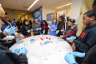 Students put on gloves before they begin extracting their DNA. Photo: Dylan Buyskes