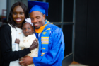 Emmanuel Nsengiyumva, a graduating student, celebrates with his wife and daughter at UB's 20th Annual ALANA Celebration of Achievement, a pre-commencement ceremony.