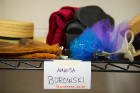 The elements of a cast member's costume sit on a shelf in the costume shop.