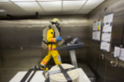 A volunteer firefighter walks on a treadmill to test the effects of different cooling interventions.
