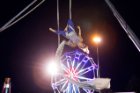 The ferris wheel serves as the backdrop for this aerial silk performer. Photo: Douglas Levere