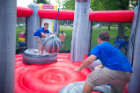 Students take a turn on the inflatable tether ball.