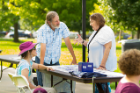 Paula Radice talks with Mary and Larry Kinney, who were representing the University Heights Arts Association.