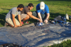 From left: Students Rohan Kuriakose, Ali Alqaraghuli and Aaron Schwab prepare the instruments for the weather balloon launch.