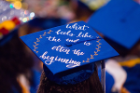 A graduate's mortarboard that reads "what feels like the end is often the beginning."