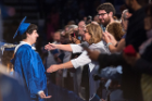 A graduate receives a well deserved hug.