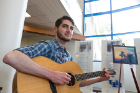 Music is art, and first-year med student Matthew Kaye plays his guitar at the Jacobs Arts Festival. Photo: Meredith Forrest Kulwicki