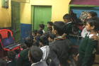 Children at Calcutta Rescue, an organization supporting free medical care, education and development to poor residents of Kolkata, watch a video of Malala Yousafzai's life story. 