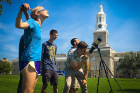 Members of UB Students for the Exploration and Development of Space (UB SEDS) gather on the Hayes Hall lawn to watch the eclipse.