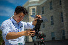Medical physics PhD student Chao Guo photographs the eclipse from the lawn of Hayes Hall on the South Campus.