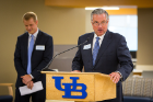 Michael E. Cain, vice president for health sciences, dean of the Jacobs School of Medicine and Biomedical Sciences, and president and CEO of UBMD Physicians Group, said the UBMD opening at Conventus is an important new piece of the academic medical center. Michael Wooten (at left) of WGRZ served as the evening’s emcee.