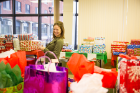 Tess Morrissey, director of the Office of Community Relations, is almost lost among the gifts.
