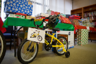 One lucky child will find a new bike under the tree. Other gifts donated include art sets, a basketball hoop, winter clothes and board games. The University Heights Tool Library also will receive some tools donated by UB employees.