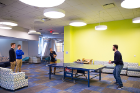 Students play some ping pong in a student lounge.