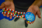 A plastic DNA chain provided by the UB GEM Community of Excellence. Free buttons were available at the performance.