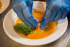 Plating the Spicy Lobster Coconut Bisque.