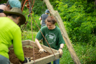 Volunteers sift through excavated soil looking for artifacts.