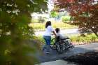 A UB employee takes a Weinberg resident for a walk on the campus.