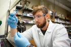 UB chemistry PhD student Steven Travis measures the volume of a chemical standard, a solution that contains known amounts of a certain chemical. Chemical standards act as a reference, enabling scientists to accurately quantify traces of chemicals found in analytical testing.