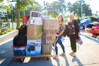 Coffeemaker? Check. Mini-fridge? Check. Smile? Check. This student has all the necessities for moving in. Photo: Douglas Levere