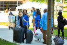 Volunteers guide students to their new digs. Photo: Douglas Levere