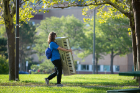 This musician-in-the-making carries a piano to Governors Complex. Photo: Meredith Forrest Kulwicki
