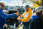 Mike Wach (left) serves some tailgate chili to Mike Freeman.