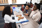 Danielle Dunn, a second-year med student, describes the structure of the human heart to Ayedi Htoo, a junior at City Honors High School, and Faith Britt, a sophomore at Niagara County Community College.