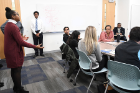 "Be yourself" and "don’t be too scripted," second-year med student Jalisa Kelly (on the left in a red sweater) advises students in a workshop on interviewing skills.