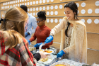 Jalisa Kelly (in orange) and Nazeela Tanweer, both second-year students, serve up home-cooked specialties.
