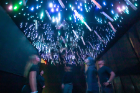 Motion-sensing technology activates lights and rain sticks suspended from the ceiling.