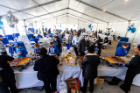 UB alumni and supporters enjoy a buffet in the alumni tent.