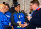 President Satish K. Tripathi shakes hands with supporters at the alumni tailgate before the game.