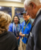 President Satish K. Tripathi and his wife, Kamlesh, greet Troy President Jack Hawkins (right) and his wife in the president's box in Ladd-Peebles Stadium before the game. 