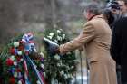 Charles F. Kreiner Jr., a trustee of Forest Lawn Cemetery, lays a wreath.
