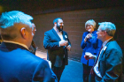 Chatting with faculty member Jonathan Shimon (center with beard), who is leading UB's PQ team, are Robin Schulze (to Shimon's left), dean of the College of Arts and Sciences, and Provost Charles F. Zukoski (far right).