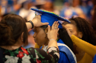 A student gets a helping hand with her mortarboard before the ALANA Celebration of Achievement in the Center for the Arts on May 16. This recognition ceremony has historically honored graduating ALANA (African, Latino/a, Asian and Native American) students. Photo: Meredith Forrest Kulwicki