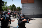 Members of the Buffalo Police Department's SWAT team approach the entrance to the Jacobs School at Washington and High streets.