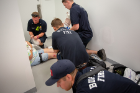 Members of the Buffalo Fire Department triage a "victim" in a hallway in the Jacobs School.