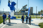 A large inflatable Victor E. Bull greets visitors, including Boldly Buffalo Steering Committee member Daniel Sperazza and Kamlesh and Satish Tripathi (center), to the Murchie Family Fieldhouse.