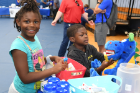 Siblings Nyeelah (left) and Noah Broughton at the UB Smiles table.