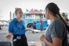 Nursing student Victoria McQueen (left) speaks with UB student Mavuri Patel at the table sponsored by the School of Nursing.