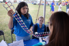 Anjali Omer, an electrical engineering PhD student, explains a DNA strand at the Genome, Environment and Microbiome (GEM) Community of Excellence table.