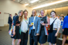 The winner of the Pitch for a Cause competition was the Stitch Buffalo team. From left, Kristie Bailey, MSW student; Dawne Hoeg, founder and director of Stitch Buffalo; President Satish K. Tripathi; Shannon Lach, MBA student; and Xingyu Chen, doctoral student in global gender studies, show off a few of Stitch Buffalo's products. Photo: Onion Studio.