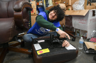Tyrus Boekhoudt, a junior studying electrical engineering, assembles a desk chair at The Teacher's Desk.