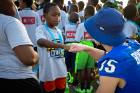 UB wide receiver Max Bowden shares a fist-bump with a participant in the youth football clinic. Photo: Meredith Forrest Kulwicki