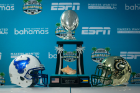 The Makers Wanted Bahamas Bowl trophy, flanked by helmets from UB and the University of North Carolina Charlotte. Photo: Meredith Forrest Kulwicki