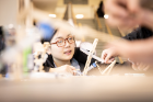 Luo Cao, a senior industrial and systems engineering major, works on her pulley.
